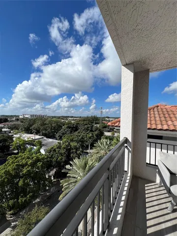 a view of balcony with wooden floor and bench