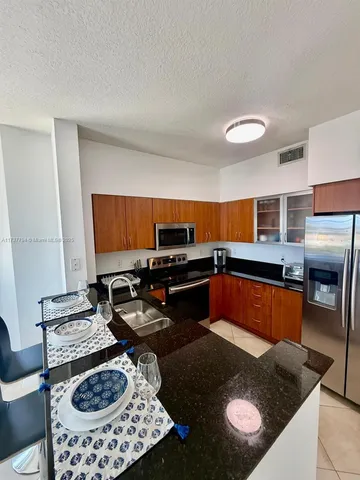 a kitchen with a sink a stove and a microwave