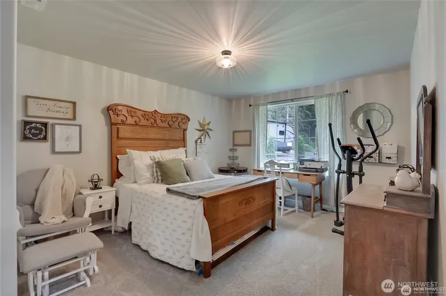 a bed room with a bed window and a chair