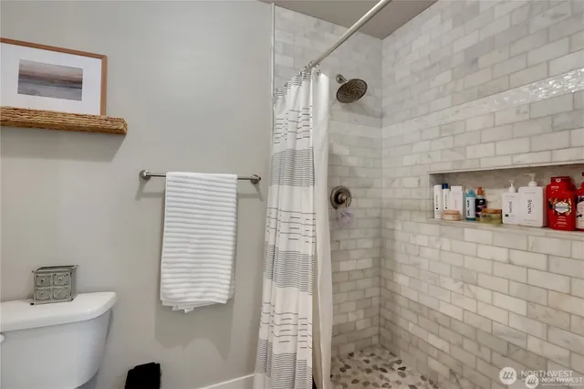 a bathroom with a toilet sink and shower