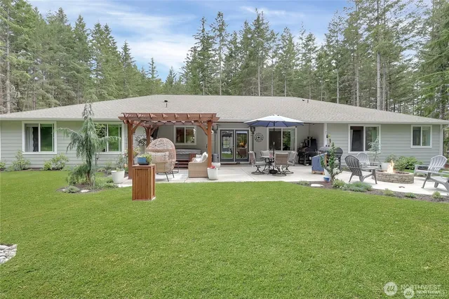 a front view of a house with garden and sitting area