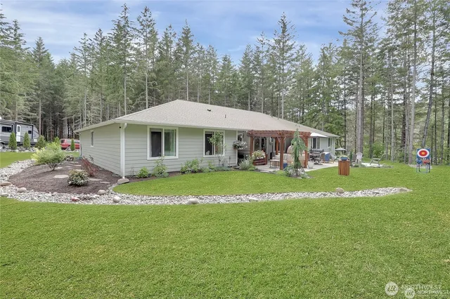 a patio with a table and chairs under an umbrella