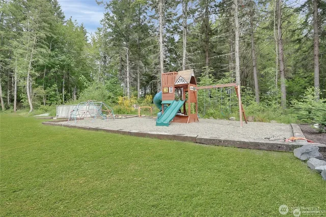 a view of playground with a slide and swing