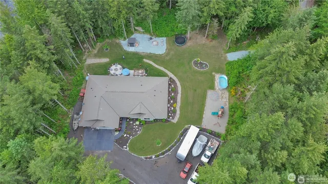 an aerial view of a house with a garden and trees
