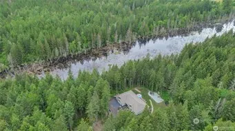 a view of a lake with a lush green forest