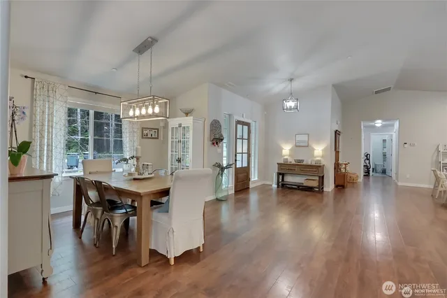 a view of a dining room with furniture and wooden floor