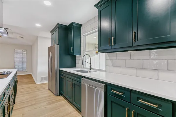 a kitchen with stainless steel appliances granite countertop a sink stove and refrigerator