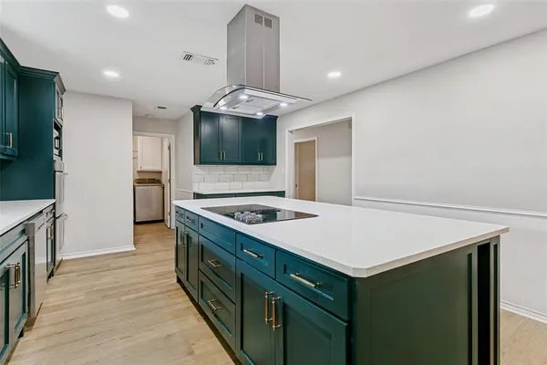 a kitchen with a stove and a microwave
