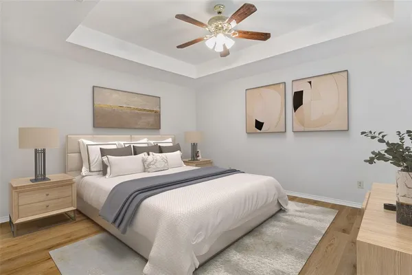 a bedroom with a large bed and a chandelier