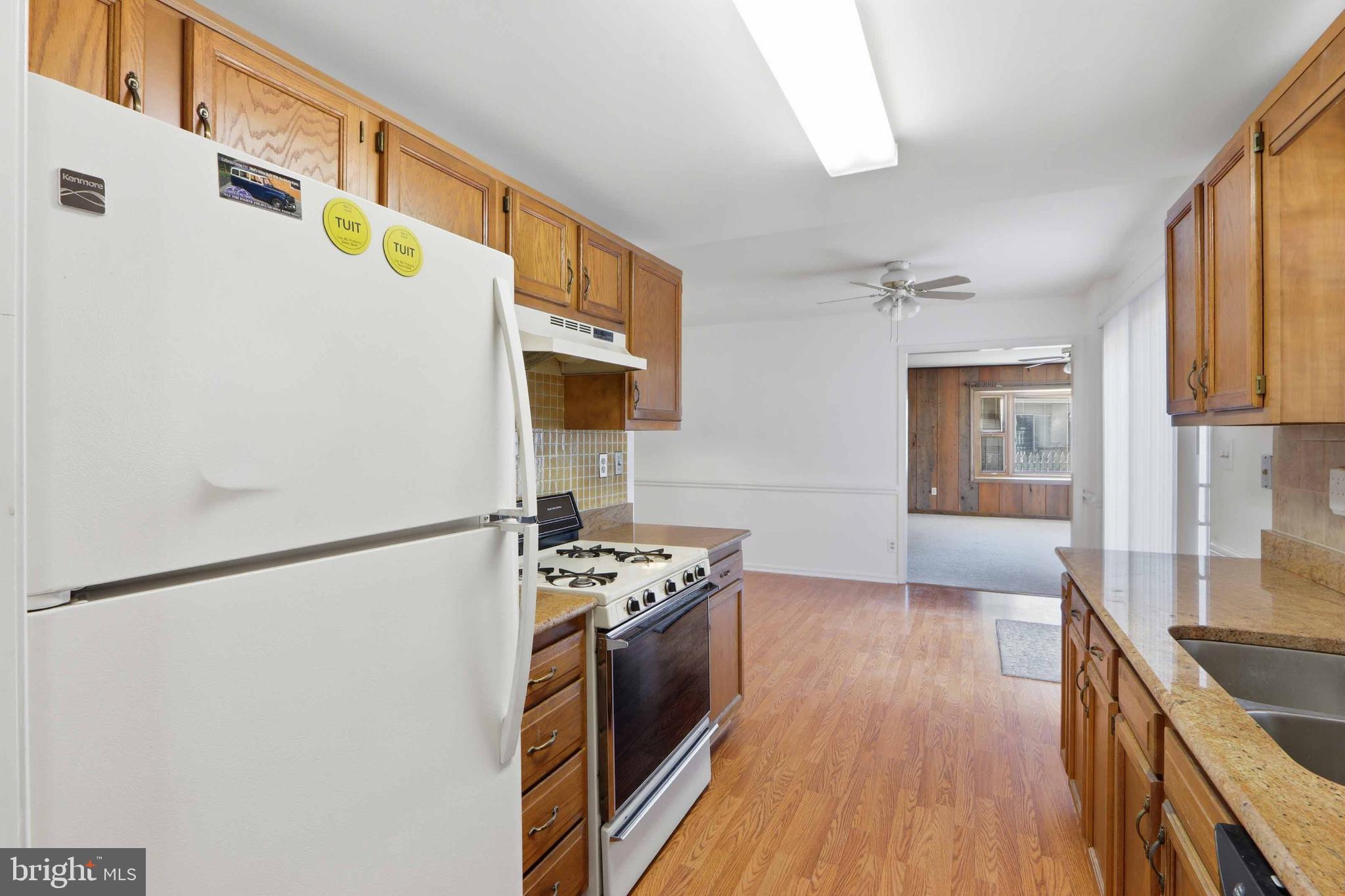 1106 Canyon Road Silver Spring, MD 20904 - Photo 23 of 43 a kitchen with stainless steel appliances a refrigerator a stove a sink and white cabinets