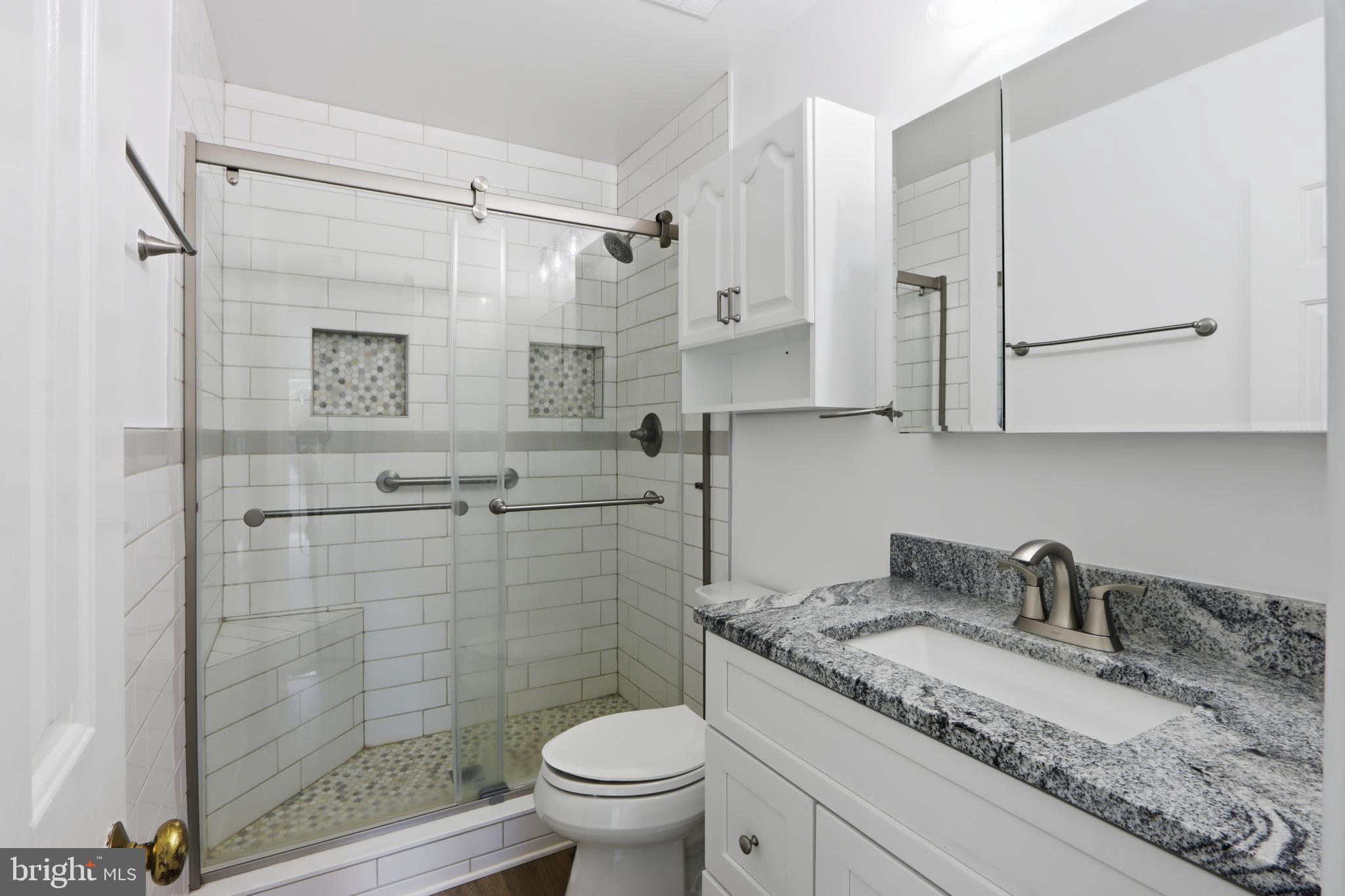 1106 Canyon Road Silver Spring, MD 20904 - Photo 9 of 43 a bathroom with a granite countertop sink toilet and shower