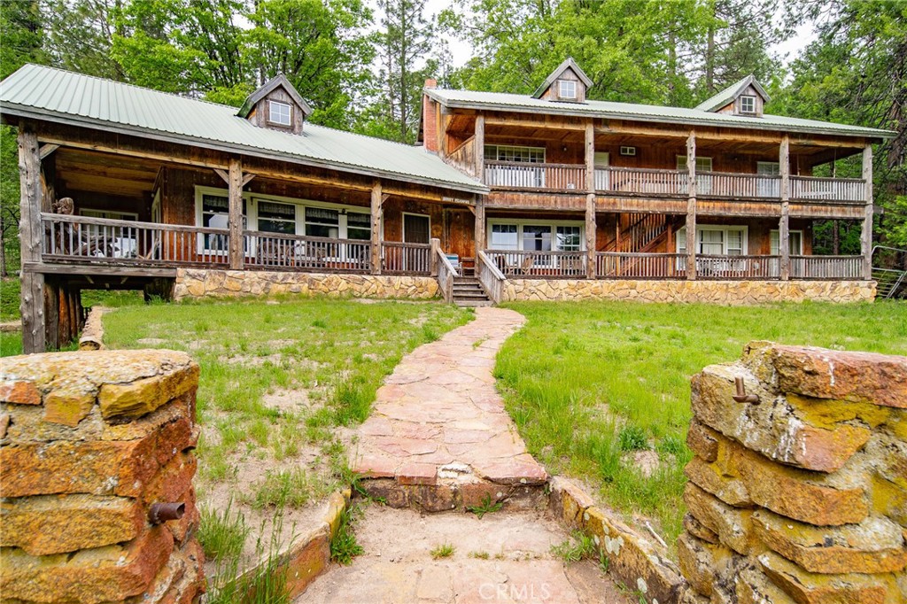 5657 Worman Road Ahwahnee, CA 93601 - Photo 2 of 46 a front view of a house with a yard table and chairs
