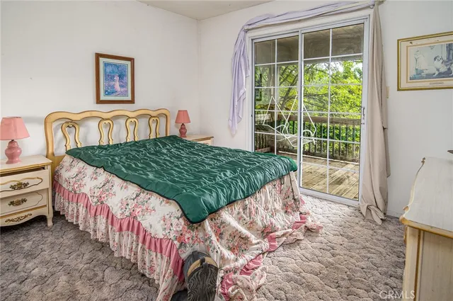 a bedroom with bed and glass walk in closet