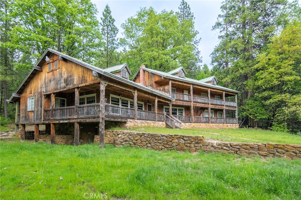 5657 Worman Road Ahwahnee, CA 93601 - Photo 4 of 40 a view of a house with a big yard and large trees