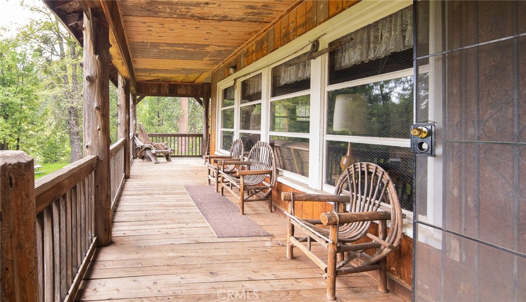 5657 Worman Road Ahwahnee, CA 93601 - Photo 9 of 40 a view of a chairs and table in patio with wooden floor and fence