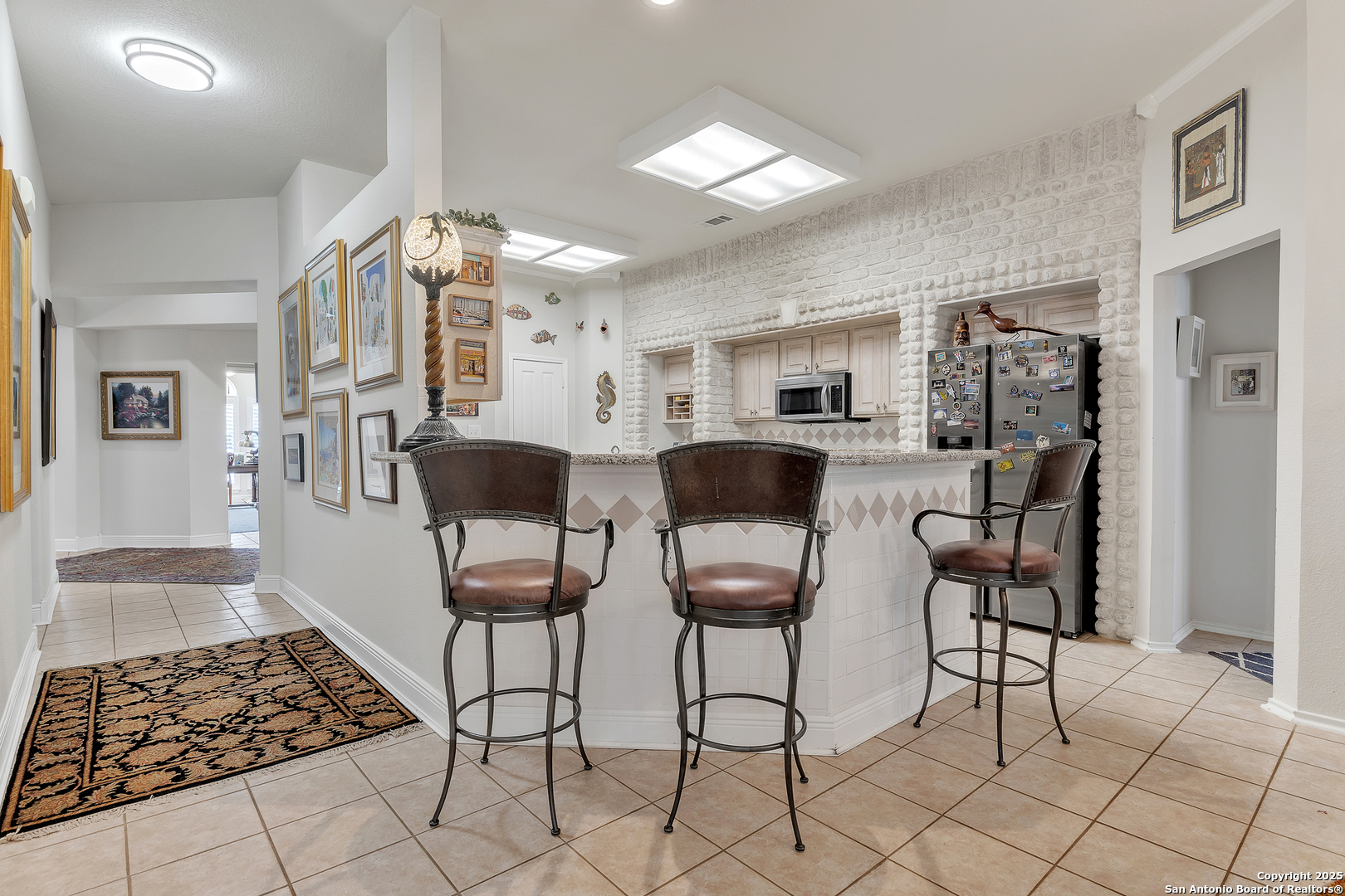 1735 Diamond Ridge San Antonio, TX 78248 - Photo 14 of 33 a kitchen with stainless steel appliances kitchen island granite countertop a refrigerator and cabinets