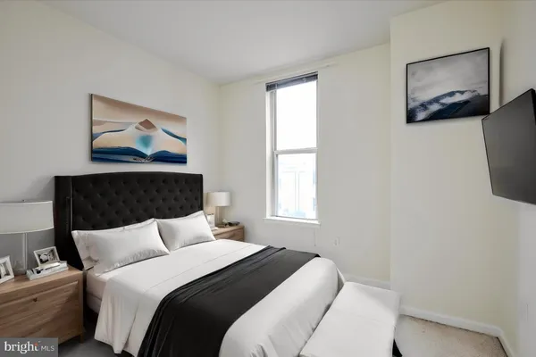 a bedroom with bed and wall painting with wooden floor
