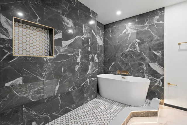 a bathroom with a bathtub and shower