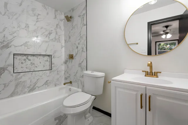 a bathroom with a sink toilet and shower