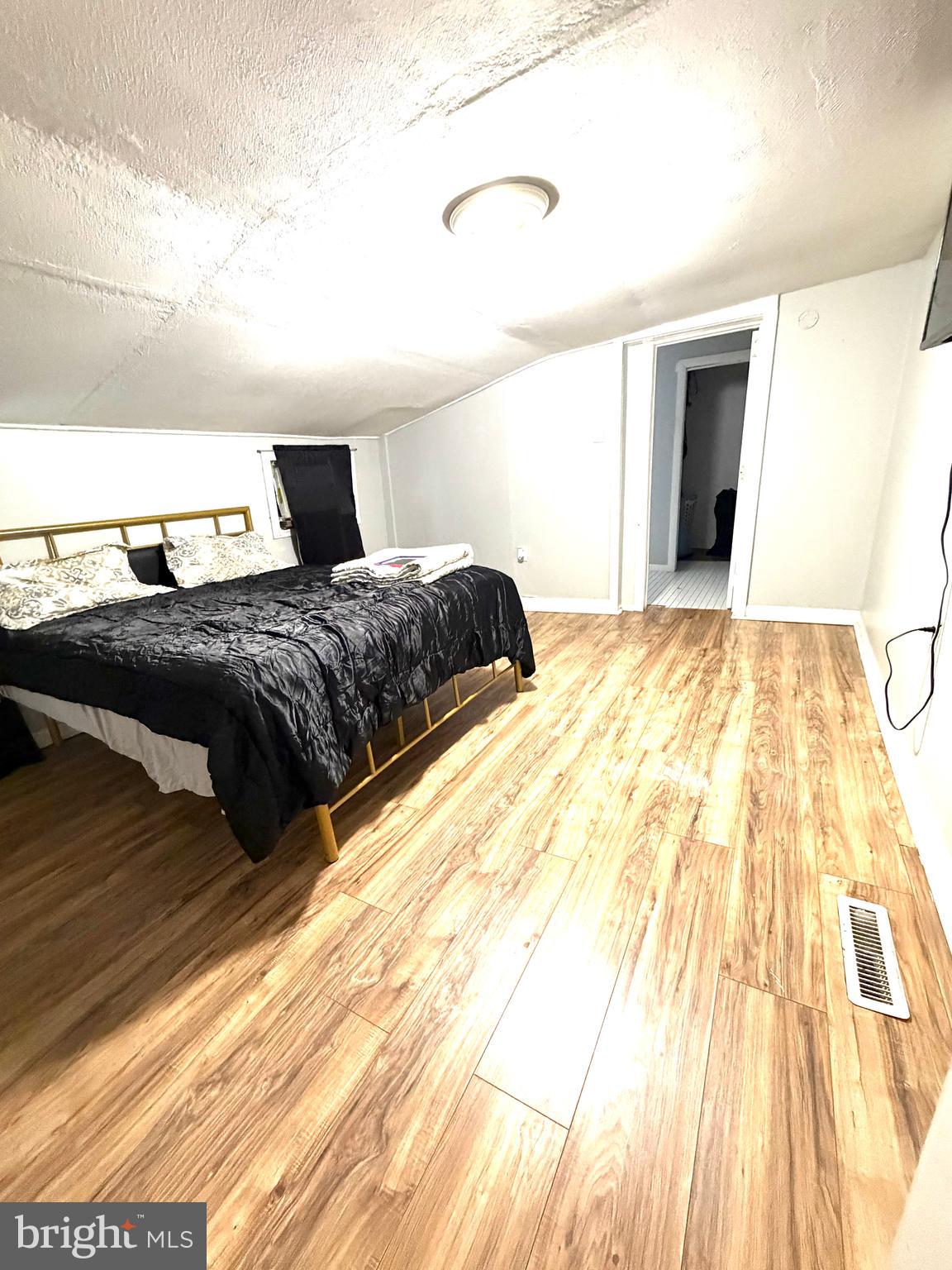 526 South 11th Street Reading, PA 19602 - Photo 11 of 22 a bedroom with a bed and a wooden floor