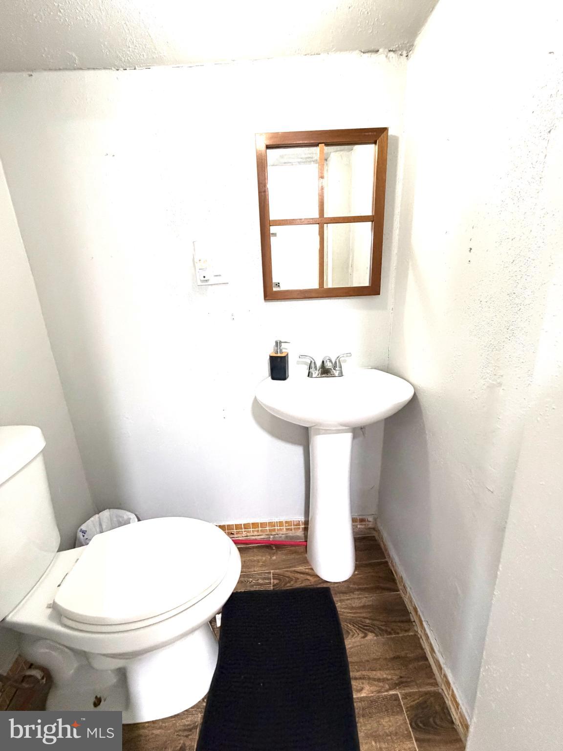 526 South 11th Street Reading, PA 19602 - Photo 5 of 22 a bathroom with a sink toilet and mirror