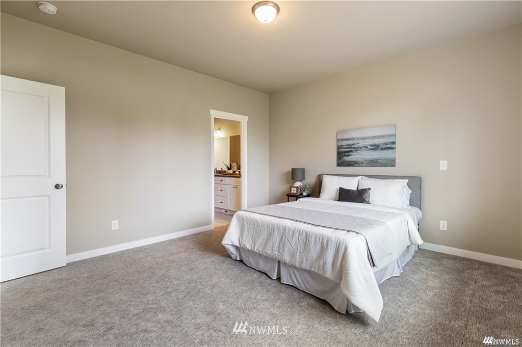 6902 Red Ridge Drive, Unit A Lynden, WA 98264 - Photo 16 of 31 a bedroom with a bed and a lamp