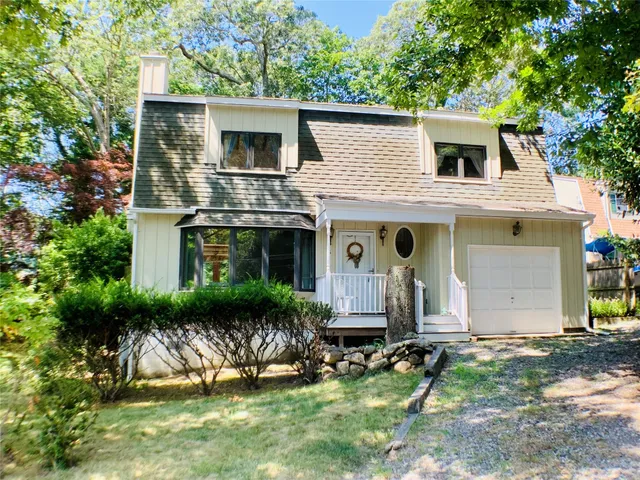 a front view of house with a garden