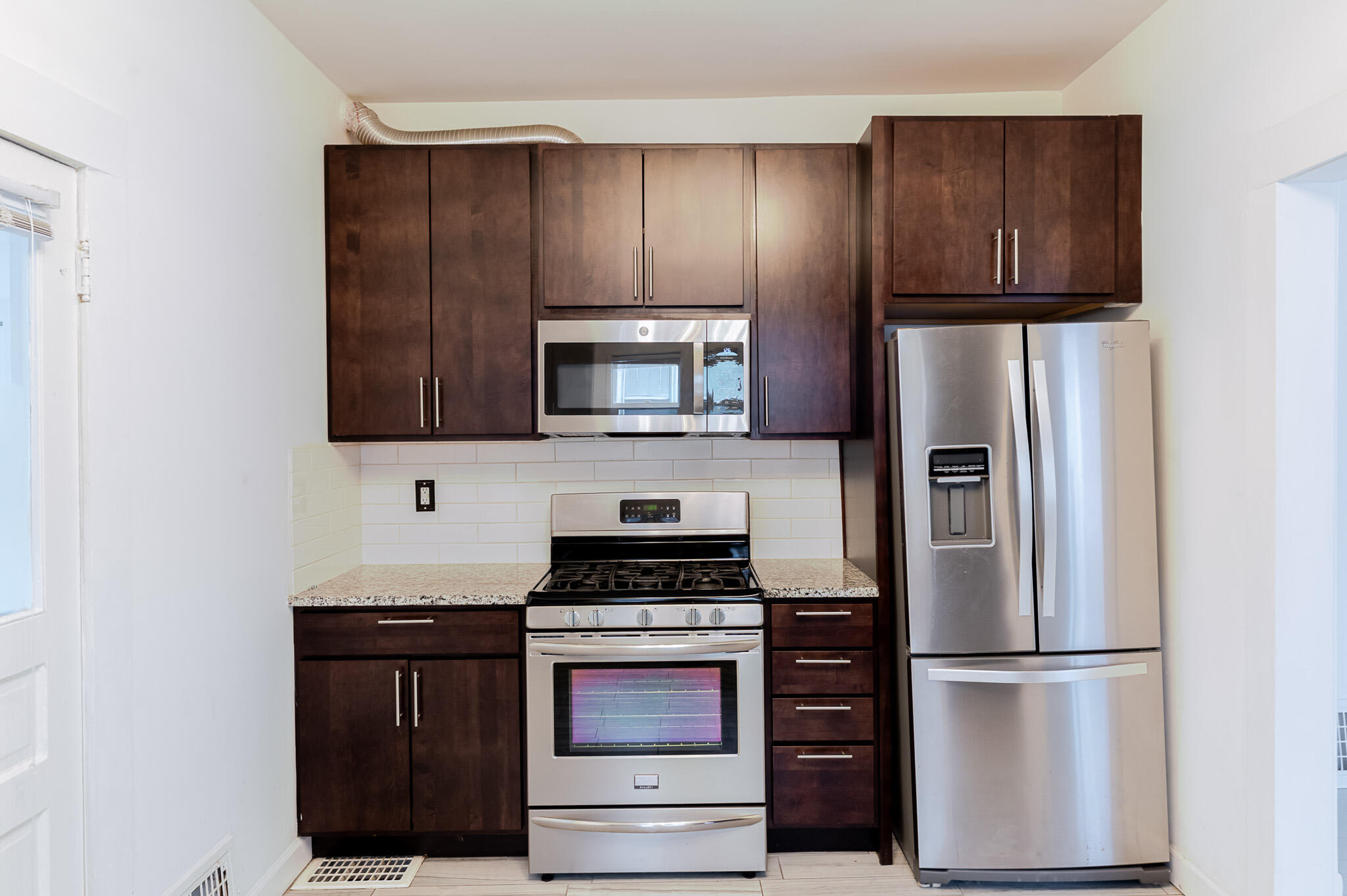306 Brown Street Valparaiso, IN 46383 - Photo 11 of 19 a kitchen with stainless steel appliances granite countertop a refrigerator stove and microwave