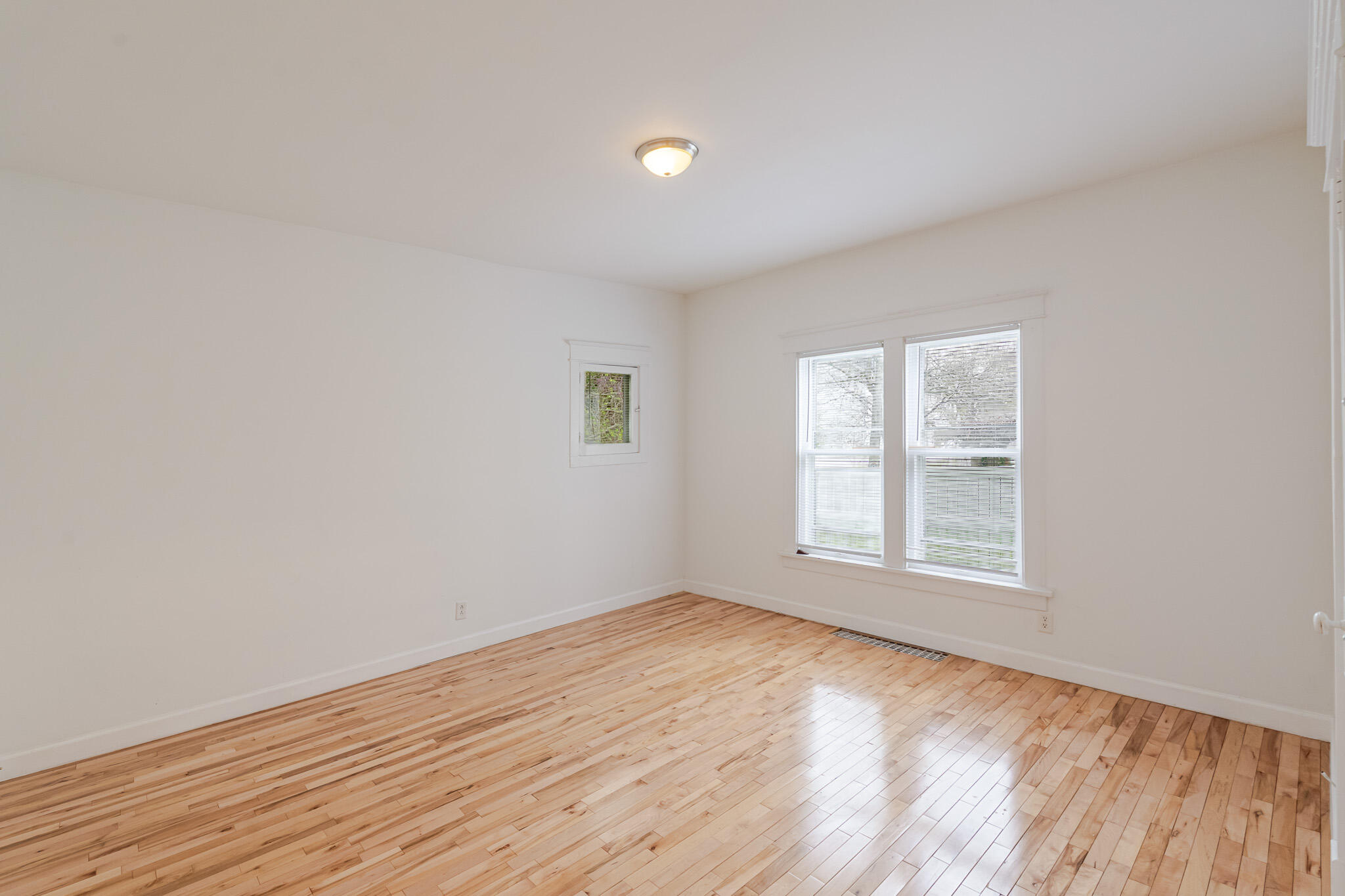 306 Brown Street Valparaiso, IN 46383 - Photo 13 of 19 an empty room with wooden floor and windows