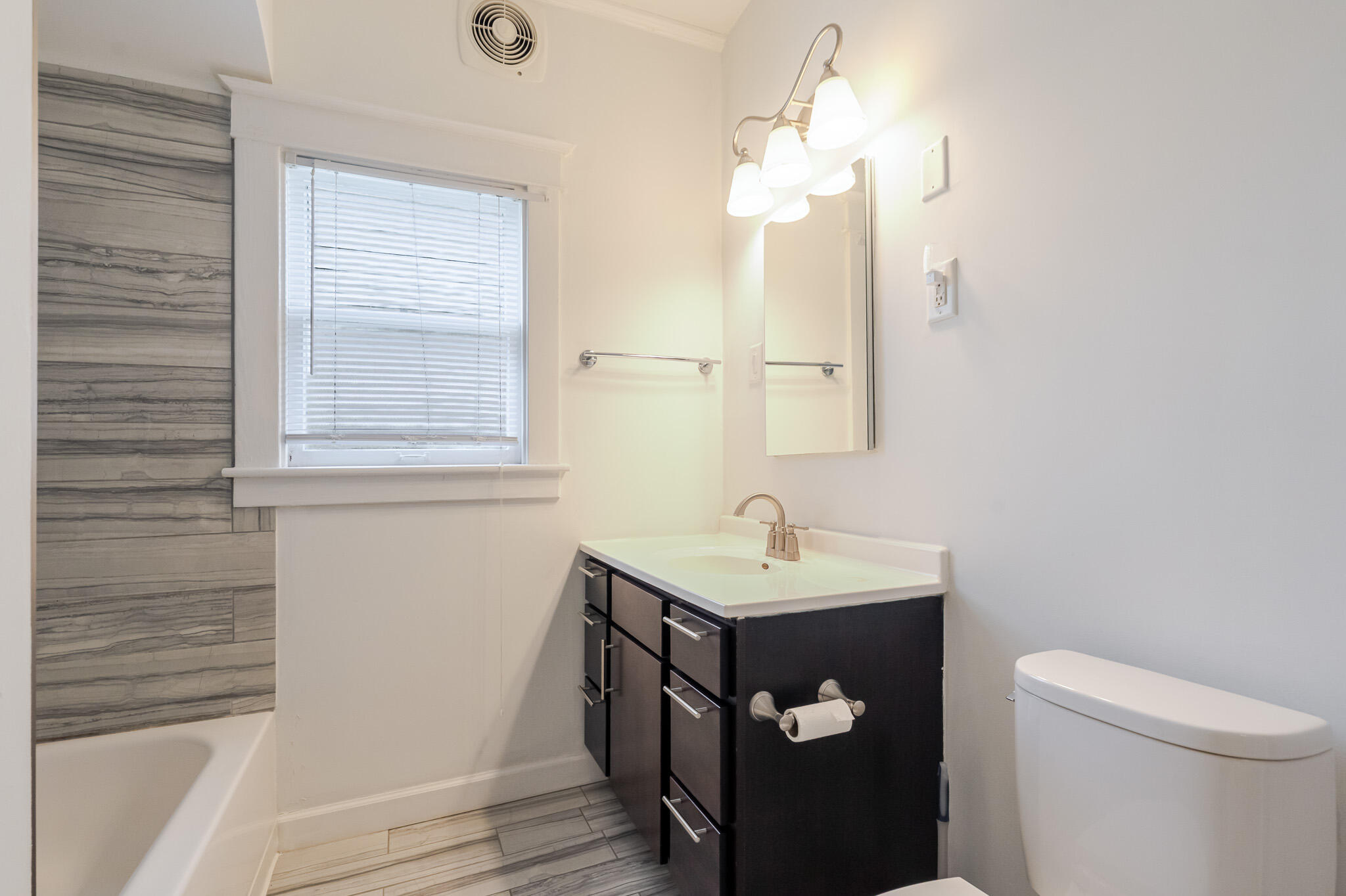306 Brown Street Valparaiso, IN 46383 - Photo 14 of 19 a bathroom with a sink a toilet and a mirror