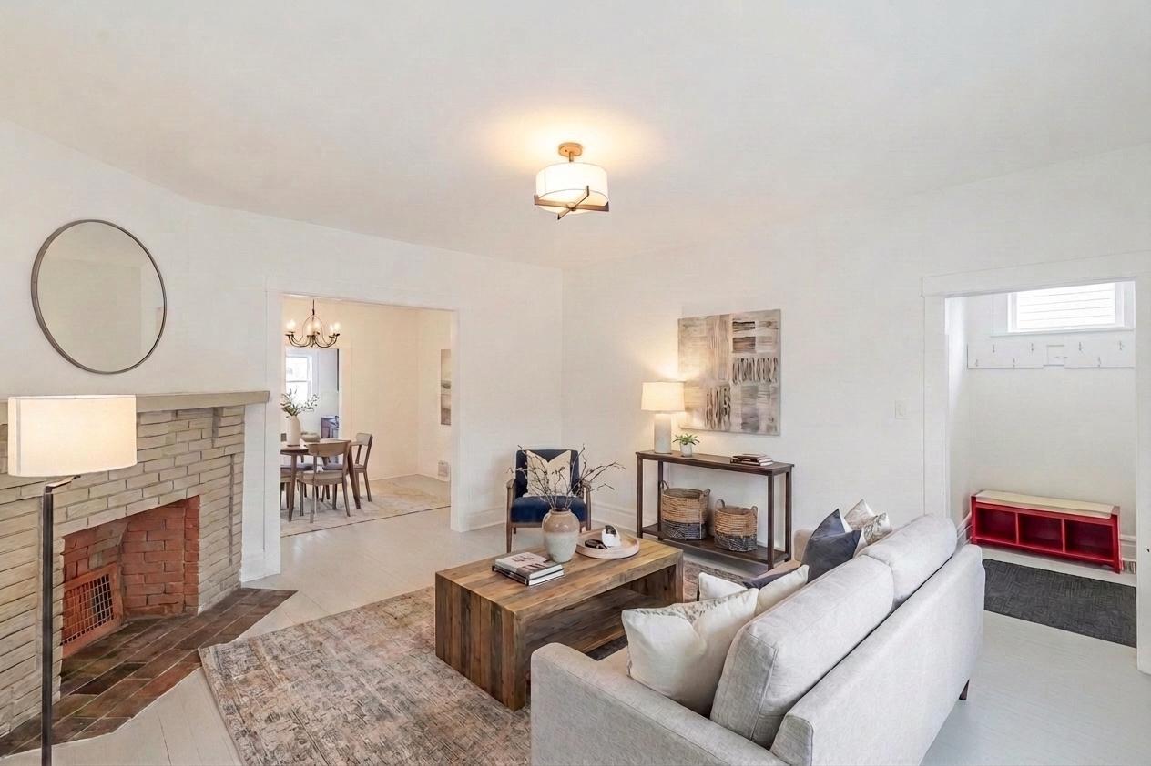 306 Brown Street Valparaiso, IN 46383 - Photo 3 of 19 a living room with furniture a fireplace and a chandelier