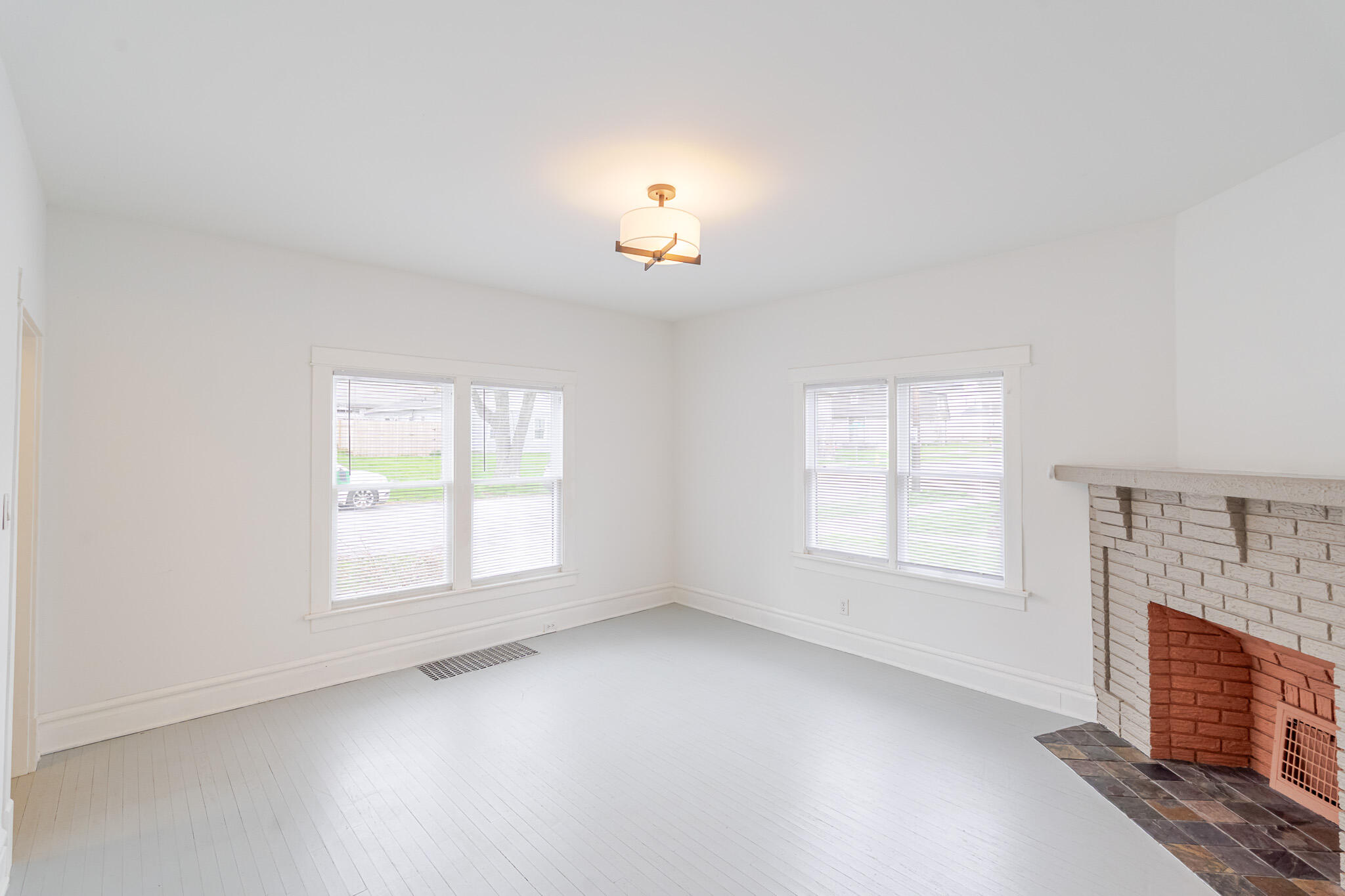 306 Brown Street Valparaiso, IN 46383 - Photo 5 of 19 an empty room with chandelier fan and windows