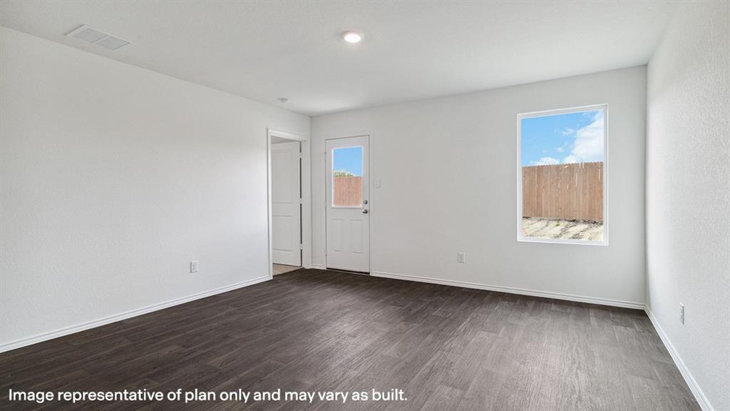 3522 Spring Time Street Forney, TX 75126 - Photo 14 of 27 Spacious room featuring wood-finish flooring, white baseboards, and a neutral wall palette