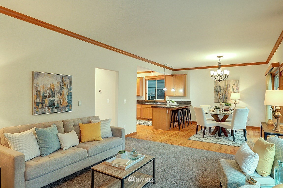 105 182nd Place Southwest, Unit B Bothell, WA 98012 - Photo 11 of 25 a living room with furniture and a dining table with kitchen view