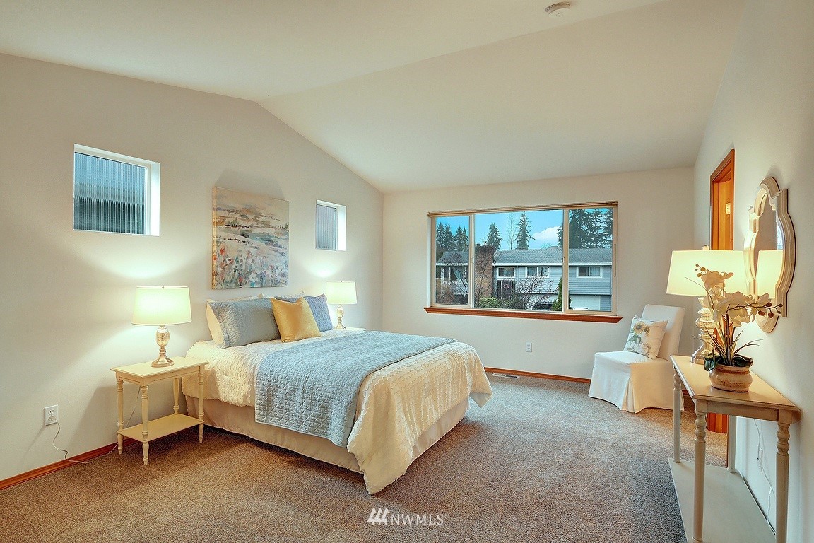 105 182nd Place Southwest, Unit B Bothell, WA 98012 - Photo 15 of 25 a bedroom with a bed and large windows
