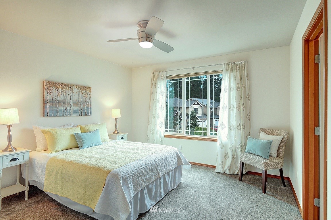 105 182nd Place Southwest, Unit B Bothell, WA 98012 - Photo 19 of 25 a bedroom with a bed and a chair