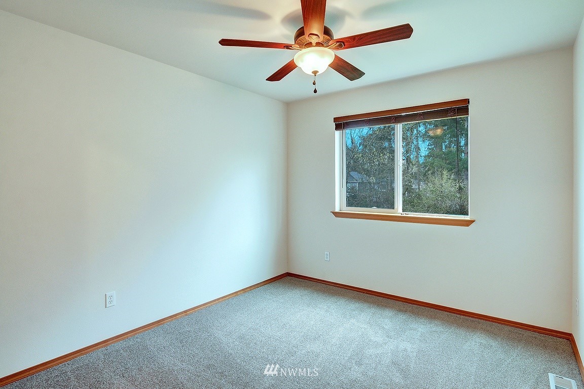 105 182nd Place Southwest, Unit B Bothell, WA 98012 - Photo 23 of 25 an empty room with a window and a fan