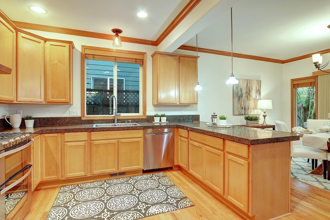 105 182nd Place Southwest, Unit B Bothell, WA 98012 - Photo 6 of 25 a large kitchen with stainless steel appliances granite countertop a sink and cabinets