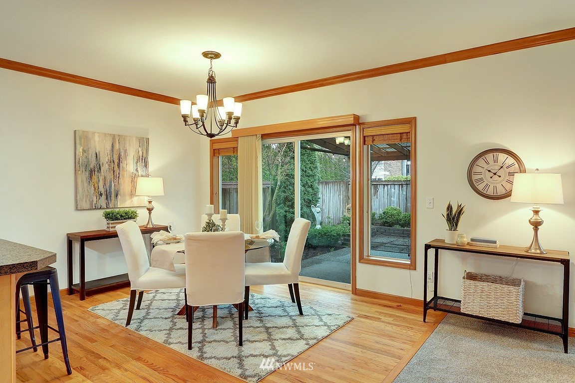 105 182nd Place Southwest, Unit B Bothell, WA 98012 - Photo 9 of 25 a dining room with furniture a chandelier and wooden floor