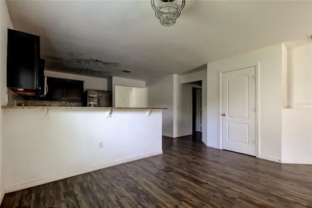 a view of a livingroom with wooden floor and a flat screen tv