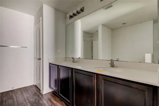 a bathroom with a double vanity sink and mirror