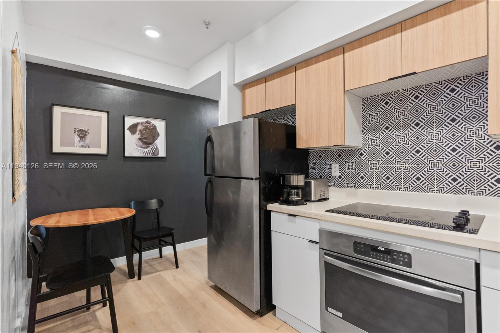 810 7th Street, Unit 102 Miami Beach, FL 33139 - Photo 2 of 21 a kitchen with stainless steel appliances a refrigerator and a stove top oven