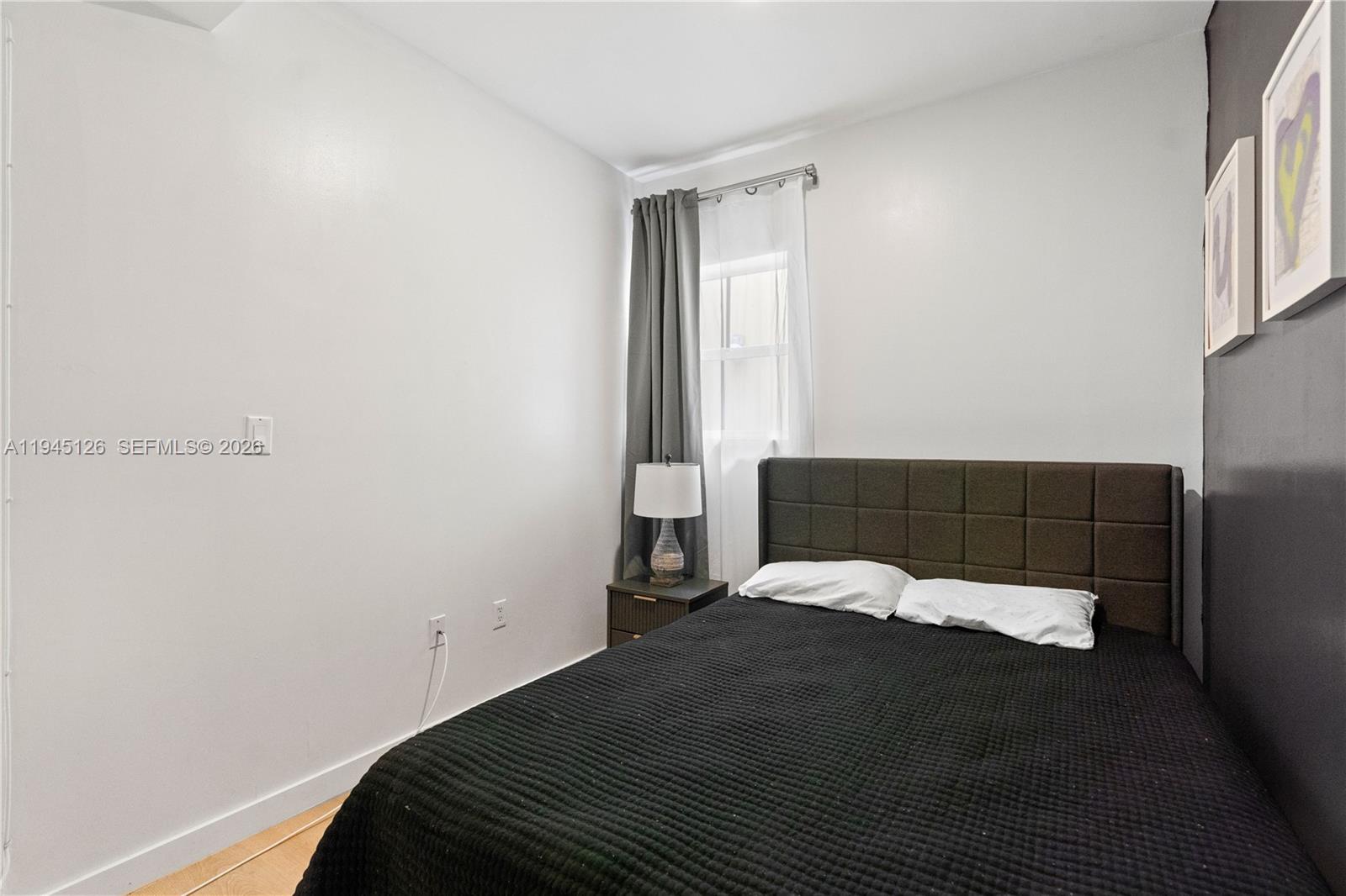 810 7th Street, Unit 102 Miami Beach, FL 33139 - Photo 6 of 21 a bedroom with a bed and a window