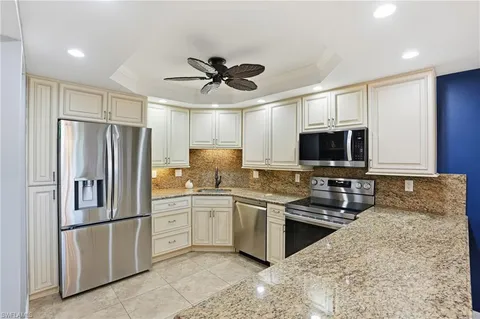 a kitchen with stainless steel appliances a refrigerator sink and microwave