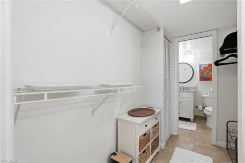 a bedroom with a bed and a lamp