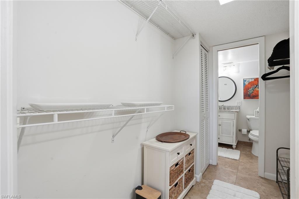 5 Bluebill Avenue, Unit 301 Naples, FL 34108 - Photo 23 of 48 a view of storage and utility room with racks on the wall