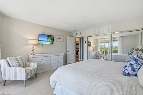 a view of a livingroom with furniture and floor to ceiling window