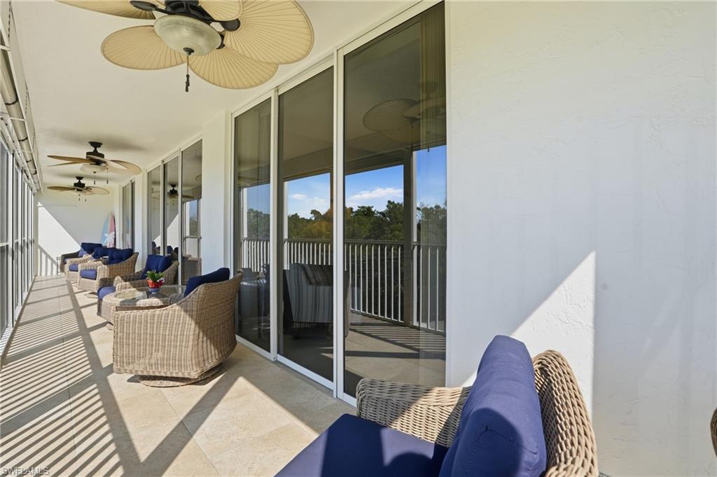 5 Bluebill Avenue, Unit 301 Naples, FL 34108 - Photo 29 of 48 a view of a livingroom with furniture and floor to ceiling window