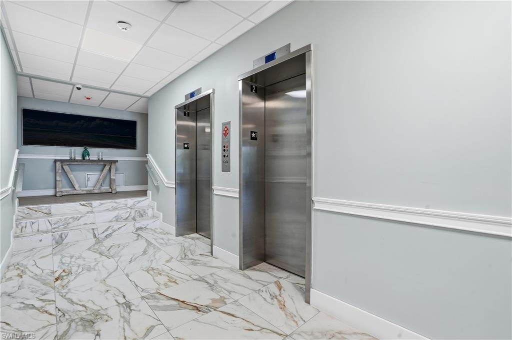 5 Bluebill Avenue, Unit 301 Naples, FL 34108 - Photo 32 of 48 a view of a livingroom with a flat screen tv
