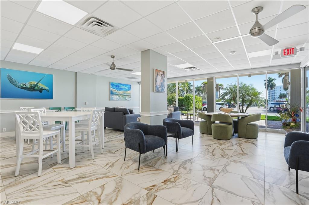 5 Bluebill Avenue, Unit 301 Naples, FL 34108 - Photo 34 of 48 a living room with furniture and a large window